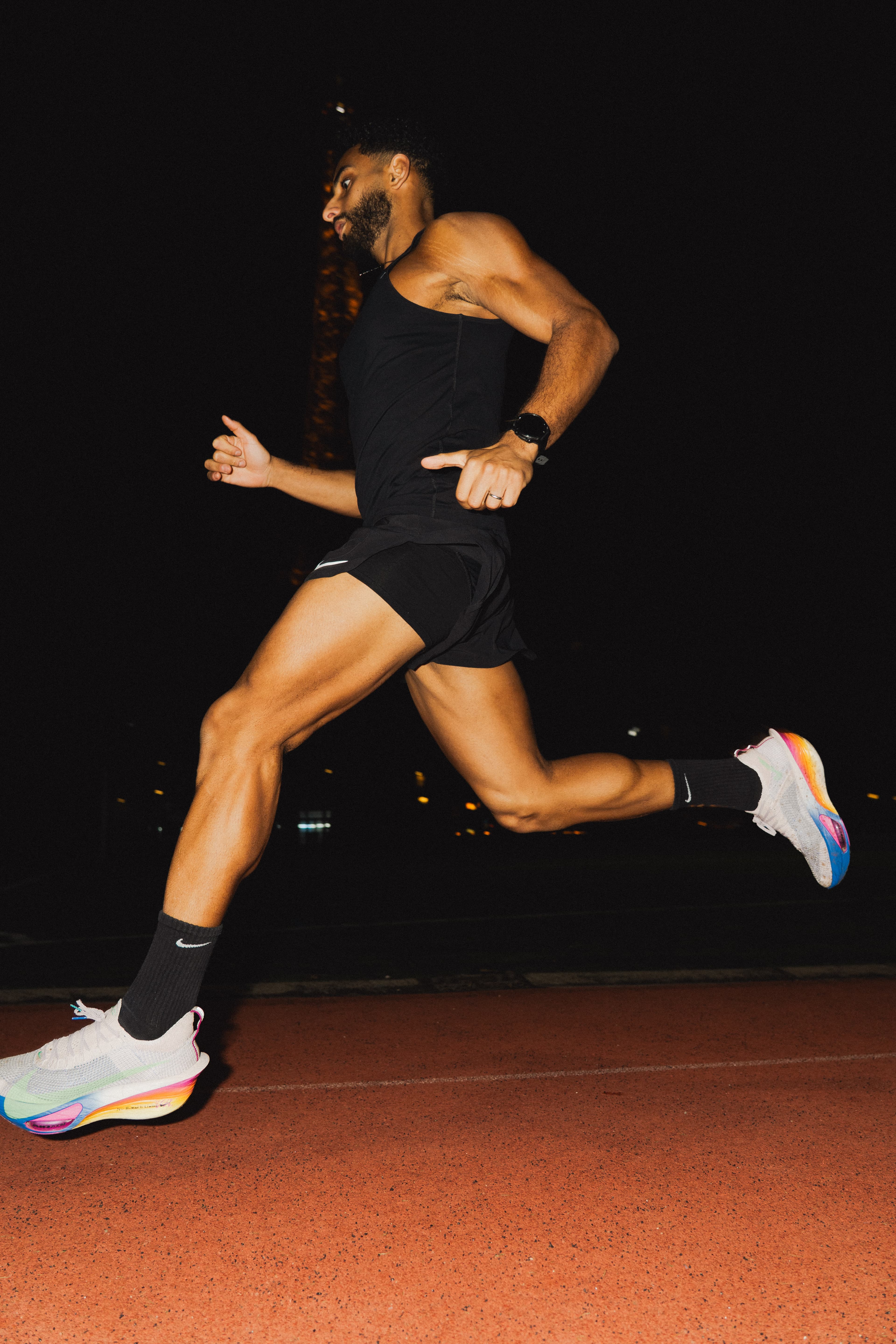 Ahmed running at night on a track